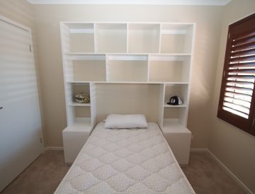 bedroom shelves built around bed
